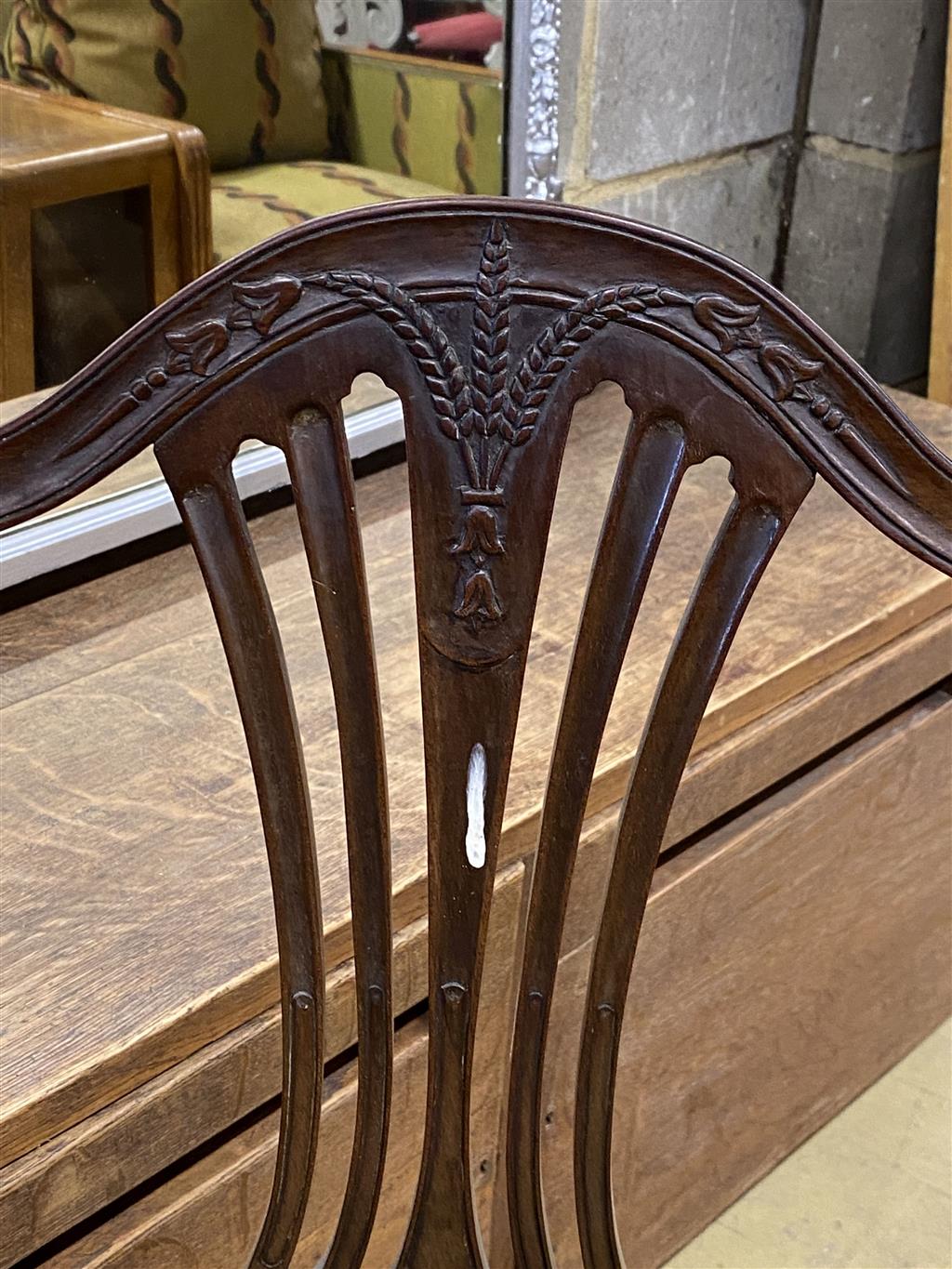 A set of six Hepplewhite style mahogany shield back dining chairs with tapestry drop in seats (two with arms)